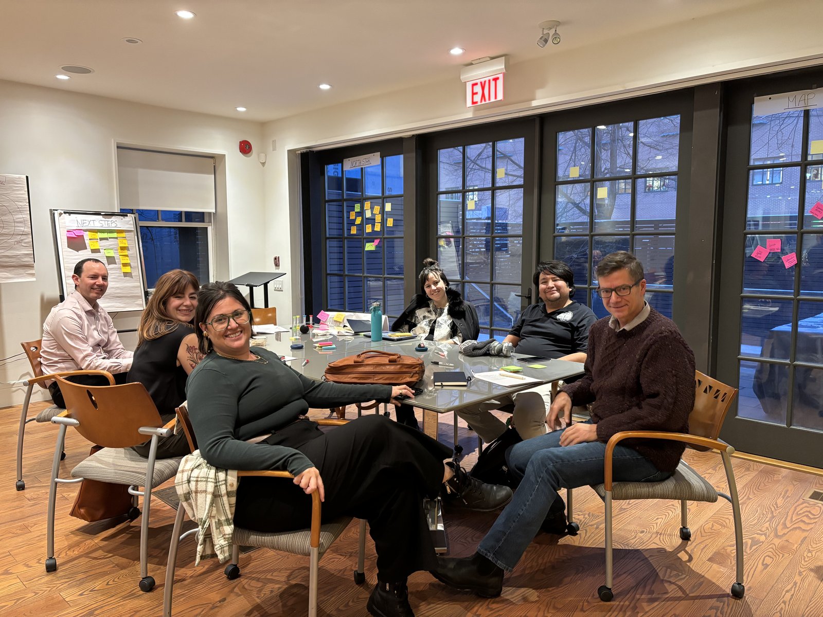 Co-designers seated around a table at the in-person review session in Toronto.